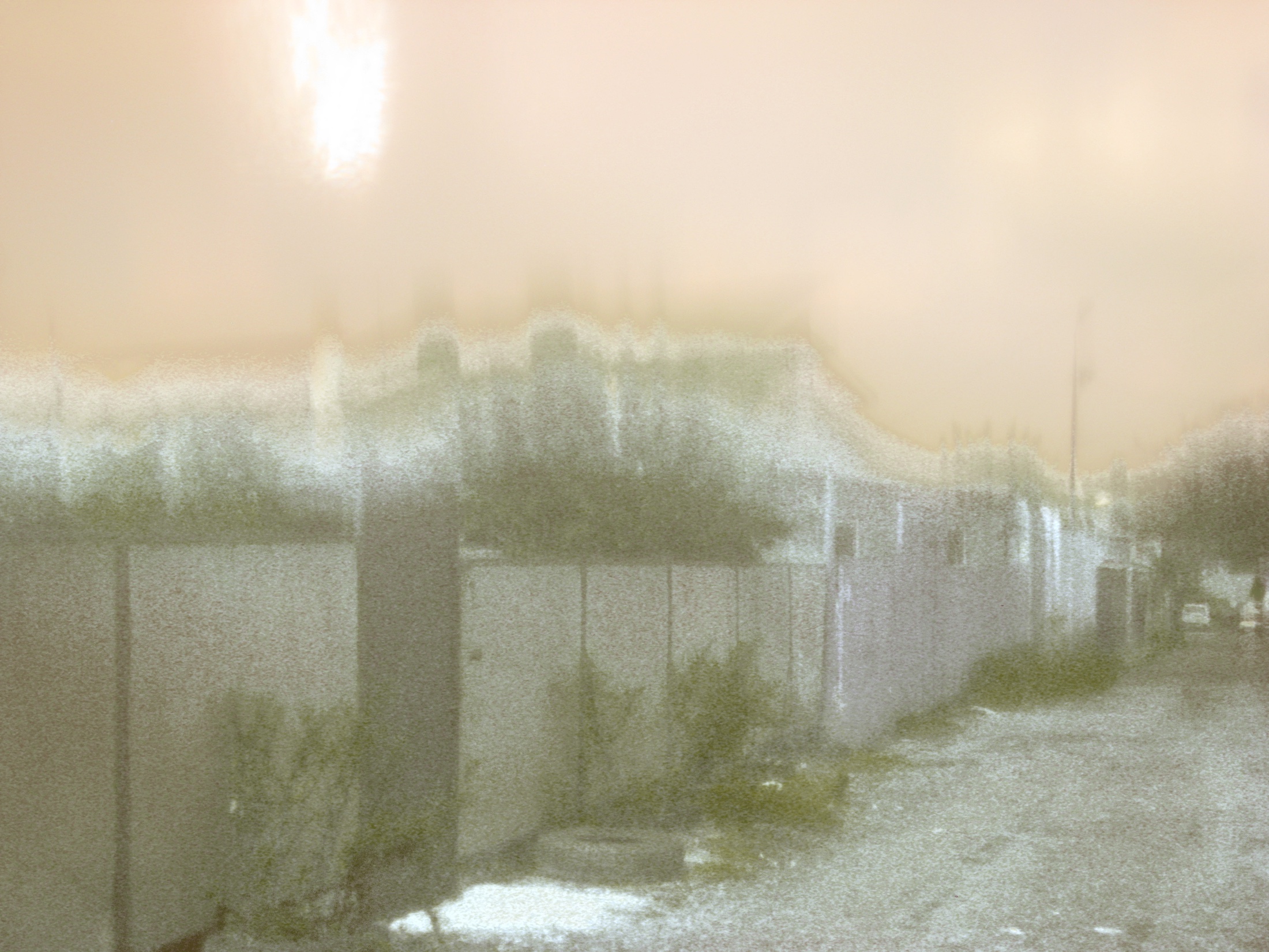 Garages photographed after the street address, with light smearing across the frame.