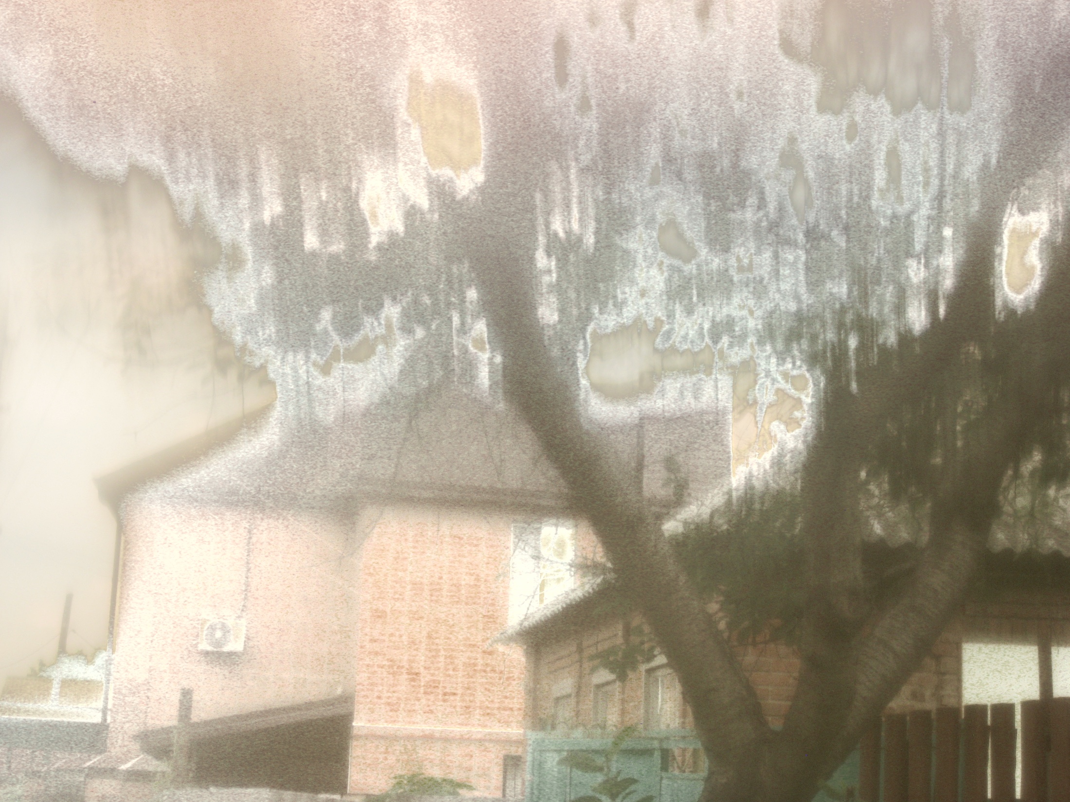 The upper edge of a building and sky dissolving through the handmade optical filter.