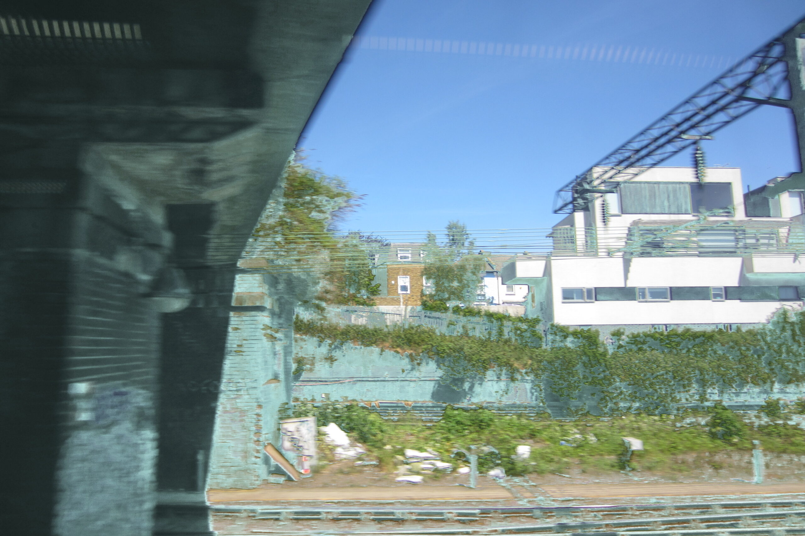 Bridge structure crossing the frame over tracks and industrial buildings.