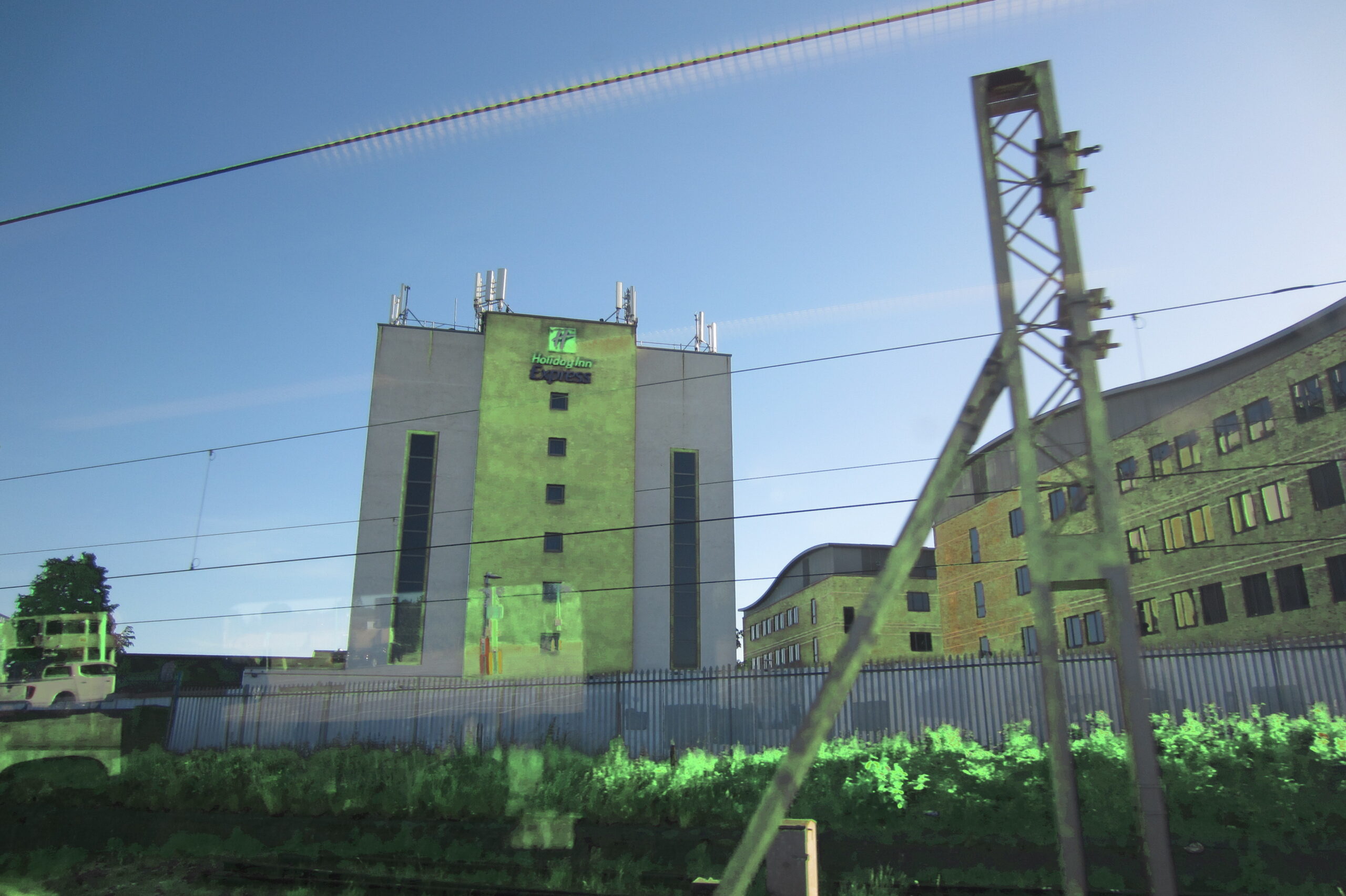 Holiday Inn building tinted green through reflection and colour shift.