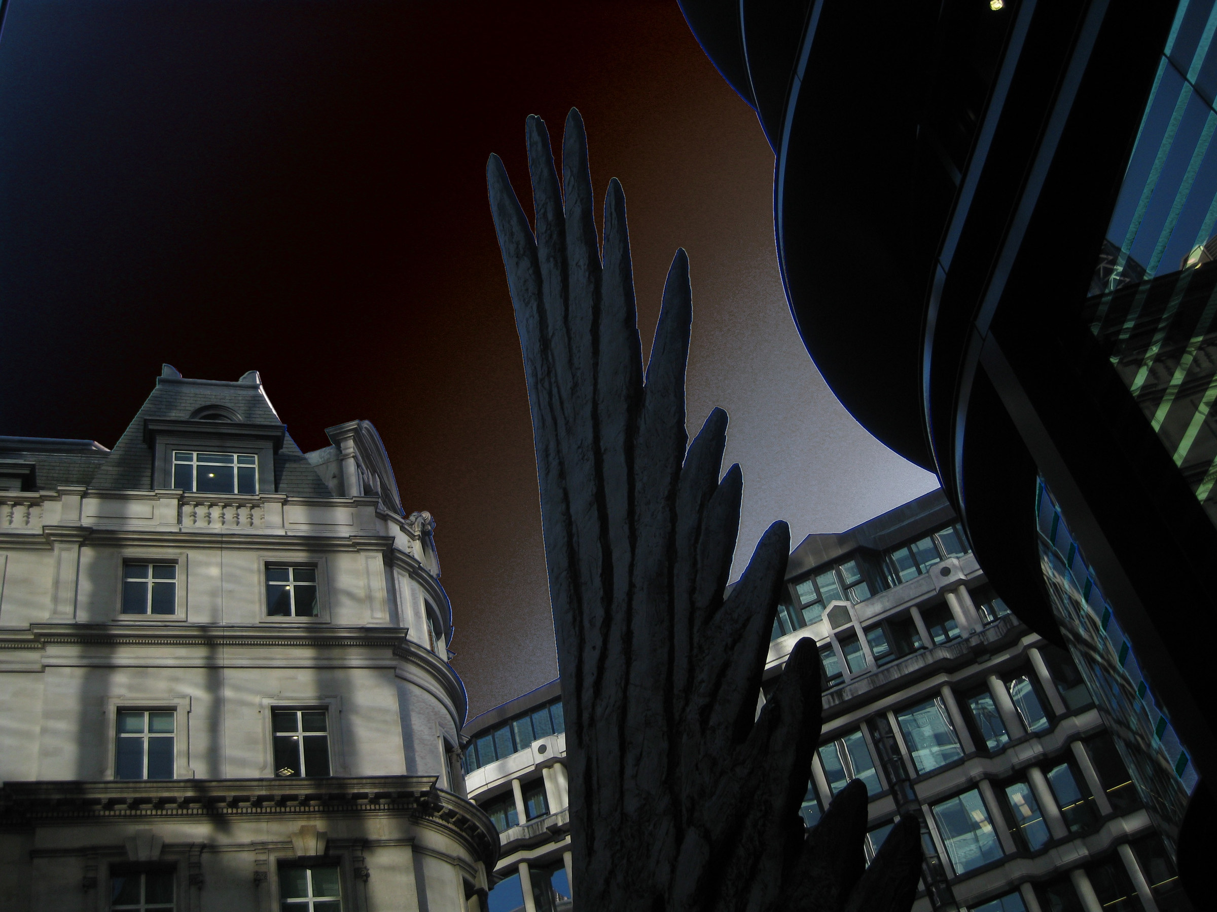 Pointed sculptural forms stand between buildings under a rust-coloured sky.