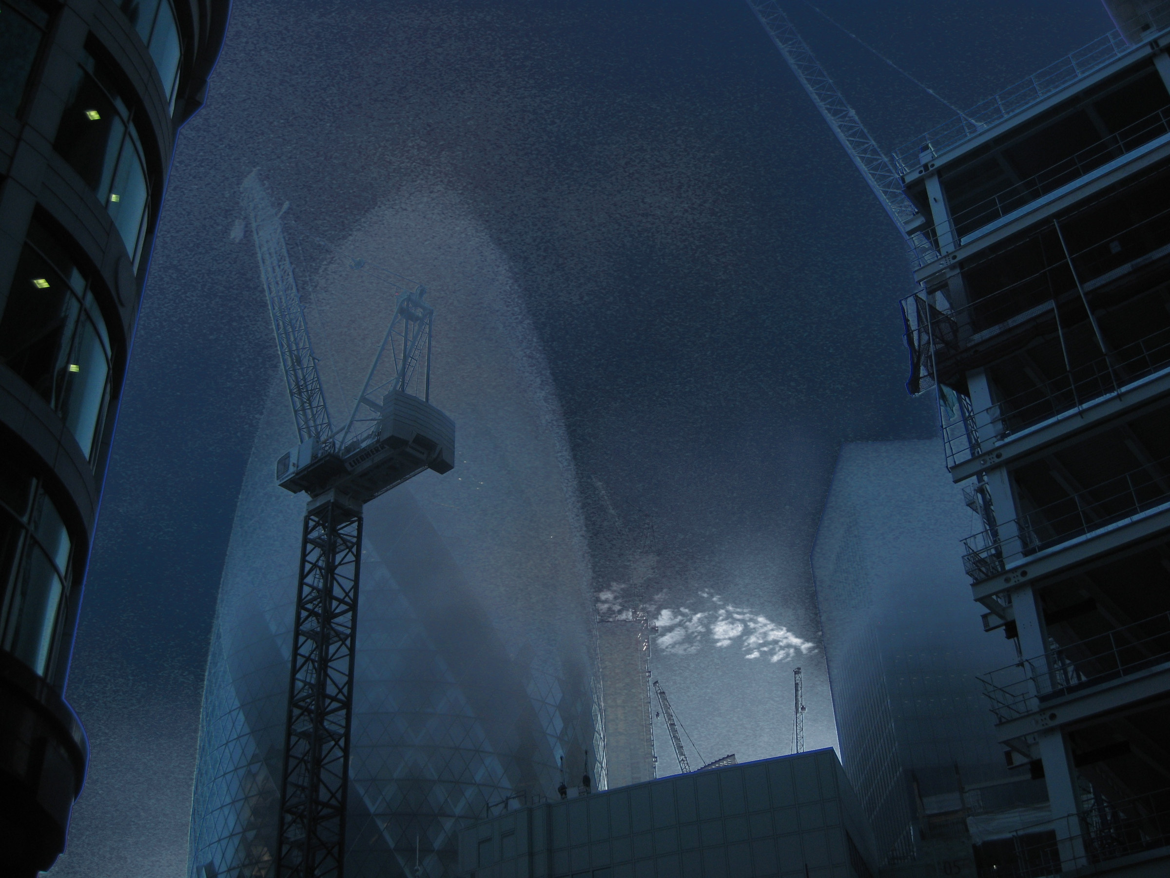 A construction crane and buildings stand beneath a layered blue sky.
